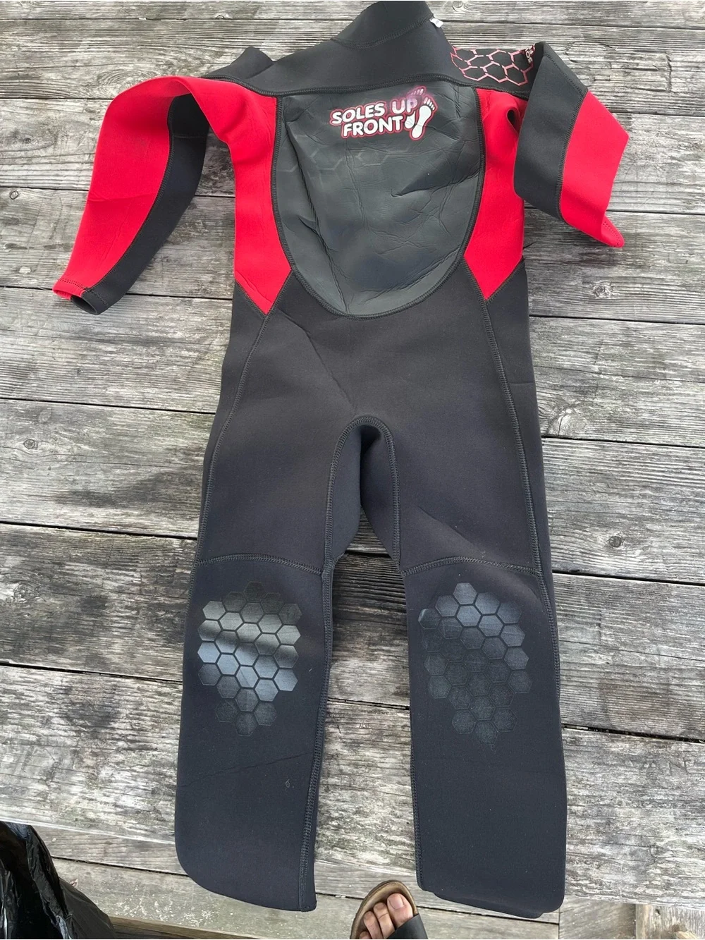 Kids Black and Red Wetsuit -soles up front 10/12 approx